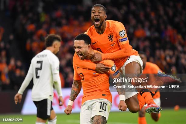 Memphis Depay of the Netherlands celebrates scoring his team's second goal with teammate Georginio Wijnaldum during the 2020 UEFA European...