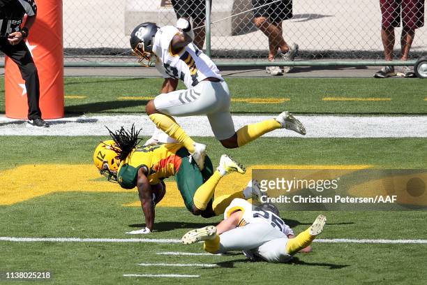 Deion Holliman of the Arizona Hotshots scores a touchdown past Jordan Martin and Ryan Moeller of the San Diego Fleet during the first half of the...
