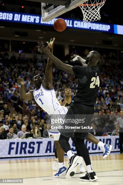 Zion Williamson of the Duke Blue Devils shoots the ball against Tacko Fall of the UCF Knights during the first half in the second round game of the...