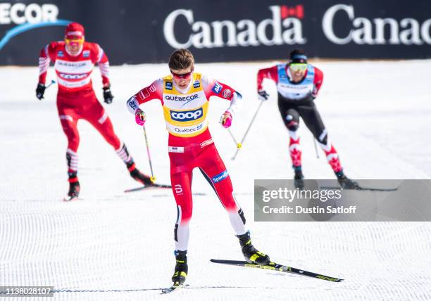 Johannes Hoesflot Klaebo of Norway approaches the finish line in first place ahead of Alexander Bolshunov of Russia and Alex Harvey of Canada in the...