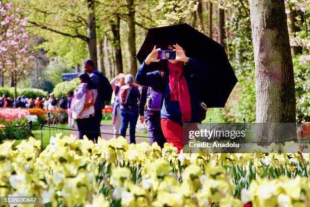 People visit the Keukenhof, one of the world's largest flower and tulip garden in Lisse, Netherlands on April 18, 2019. This year's theme of the...