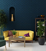 Colorful hipster living room with blue brick wall and yellow sofa, bohemian style