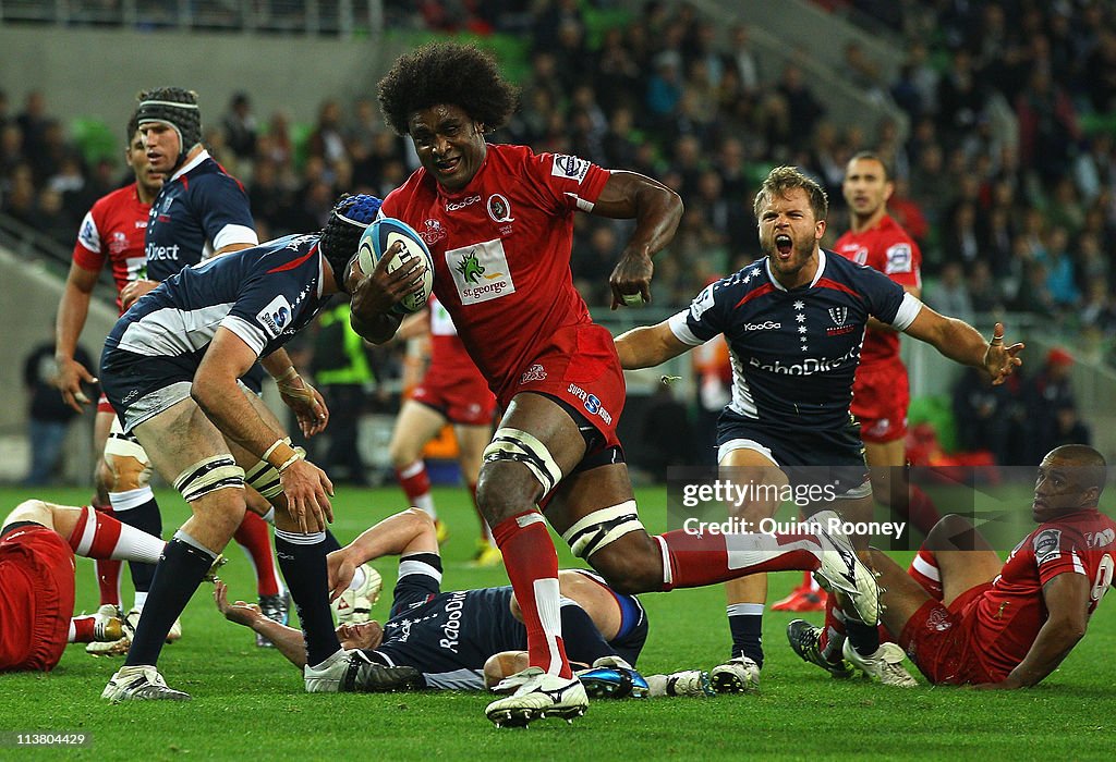 Sam Rjike Rugby Radike Samo of the Reds breaks through the Rebels defence to score a ...