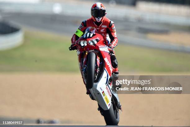 Colombian 's Honda CBR 1000 RR Formula EWC rider N°111 Yonny Hernandez lifts the front wheel after the second qualifying practise session, on April...