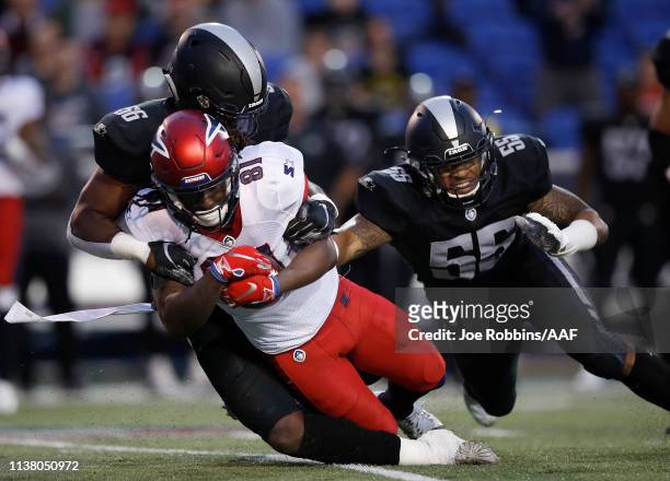 Alton "Pig" Howard of the Memphis Express is tackled by Beniquez Brown and Shaheed Salmon of the Birmingham Iron during the first quarter of their...