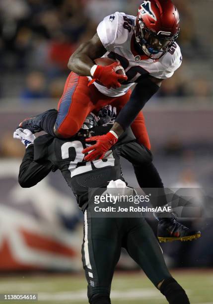 Zac Stacy of the Memphis Express leaps over Bradley Sylve of the Birmingham Iron during the first half of their Alliance of American Football game at...