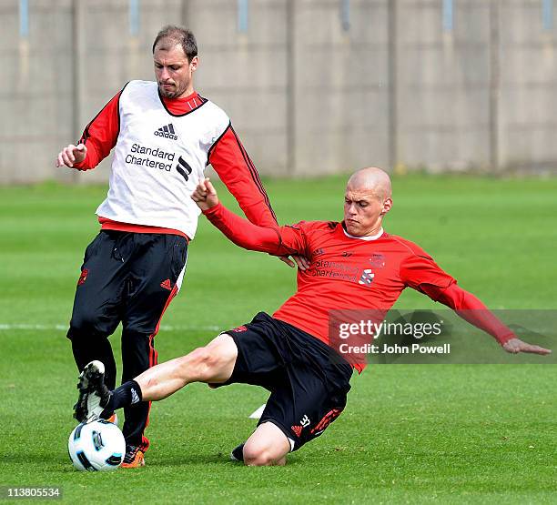 Milan Jovanovic and Martin Skrtel of Liverpool in action during a Liverpool training session at Melwood Training Ground on May 6, 2011 in Liverpool,...