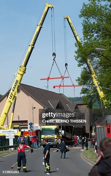 Members of the rescue services work at the scene of a school bus crash in the western German city of Gummersbach on May 6, 2011. The two drivers and...