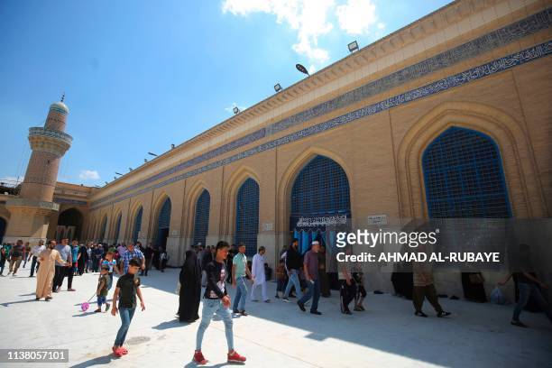 Iraqis and Sunni pilgrims visit the Abdul Qadir Gilani Mosque in the capital Baghdad on April 19, 2019.