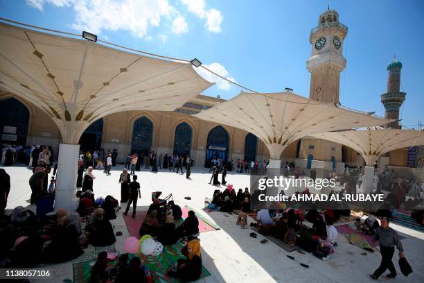 Iraqis and Sunni pilgrims visit the Abdul Qadir Gilani Mosque in the capital Baghdad on April 19, 2019.