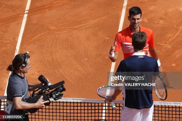 Serbia's Novak Djokovic and Russia's Daniil Medvedev shake hands at the end of the quarter final tennis match on the day 7 of the Monte-Carlo ATP...