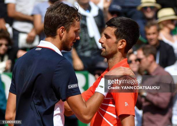 Serbia's Novak Djokovic and Russia's Daniil Medvedev talk to each other at the end of the quarter final tennis match on the day 7 of the Monte-Carlo...