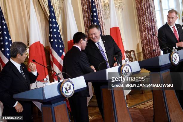 Japan's Defense Minister Takeshi Iwaya and acting US Secretary of Defense Patrick Shanahan watch as Japan's Foreign Minister Taro Kono and US...