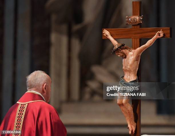 Pope Francis watches a crucifix during the Celebration of the Lord's Passion on Good Friday at St Peter's Basilica, on April 19, 2019 in the Vatican....