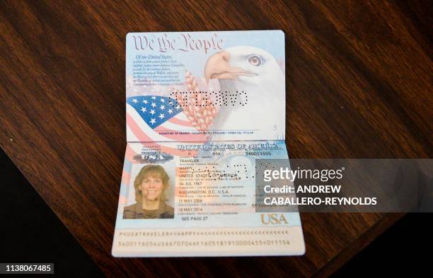 Cancelled/ example US passport lies open on a desk in an office of the mostly abandoned Venezuelan embassy in Washington, DC on April 19, 2019. -...