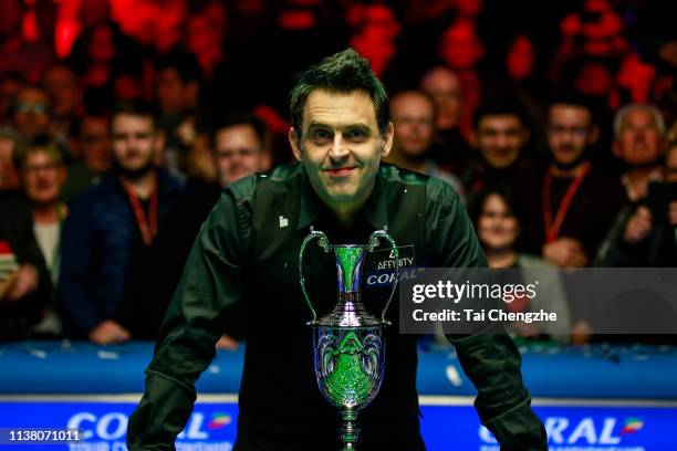 Ronnie O'Sullivan of England celebrates with the trophy after winning the final match against Neil Robertson of Australia on day six of 2019 Coral...