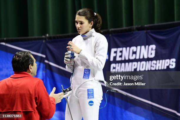 Andrea Vittoria Rizzi of St. John's talks to her coach during a timeout against Anne Cebula of Columbia during the Division I Women's Fencing...
