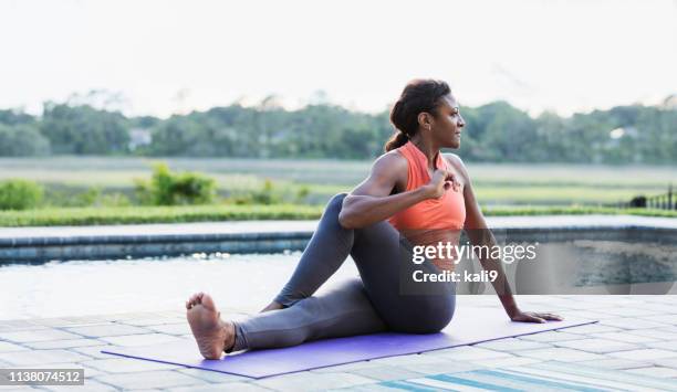 mature african-american woman exercising, stretching - black woman yoga stock pictures, royalty-free photos & images