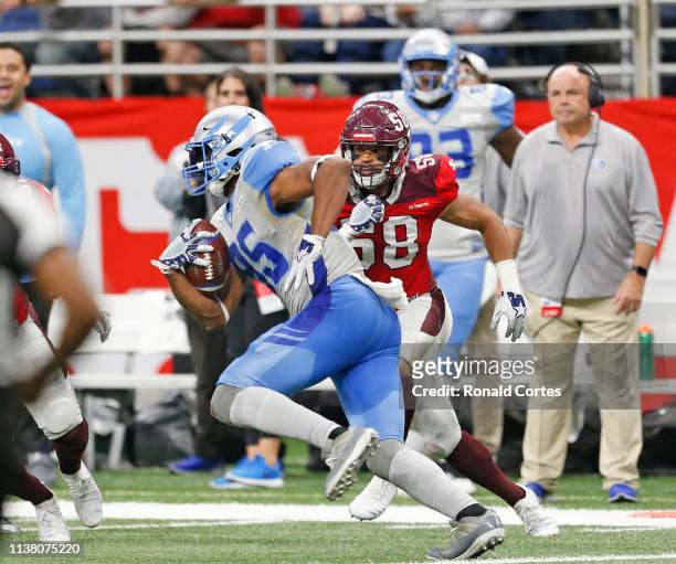 Tyrone Holmes of the San Antonio Commanders tries to stop Nick Truesdall of the Salt Lake Stallions at Alamodome on March 23, 2019 in San Antonio,...