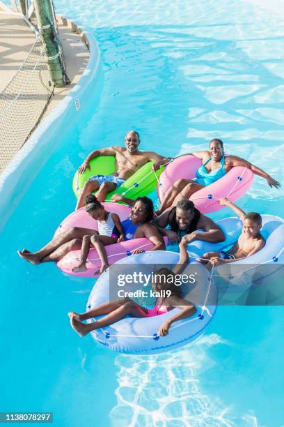 multi-generation family at water park on lazy river - boy river looking at camera stock pictures, royalty-free photos & images