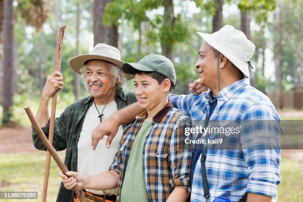 famiglia ispanica multi-generazione che escursioni nei boschi - family hiking in spring outdoors foto e immagini stock