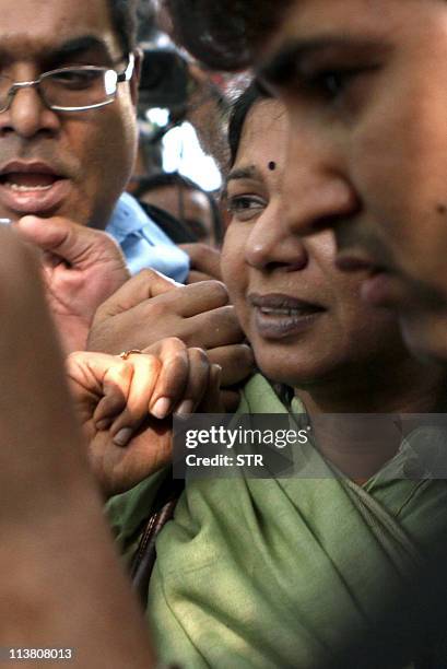 Dravida Munnetra Kazhagam Member of Parliament, Kanimozhi is escorted outside a CBI court where she appeared in connection with the 2G spectrum scam...