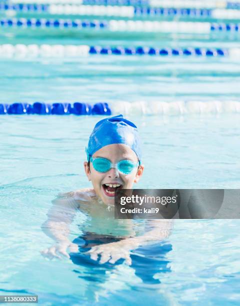 boy with swim cap and goggles swimming in pool - swimming lane marker stock pictures, royalty-free photos & images