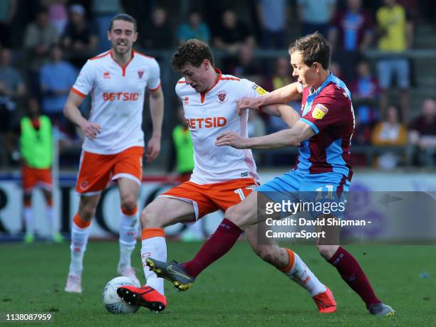 Blackpool's Matty Virtue-Thick battles with Scunthorpe United's Josh Morris during the Sky Bet League One match between Scunthorpe United and...