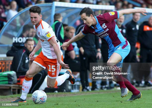 Blackpool's Jordan Thompson gets away from Scunthorpe United's Josh Morris during the Sky Bet League One match between Scunthorpe United and...