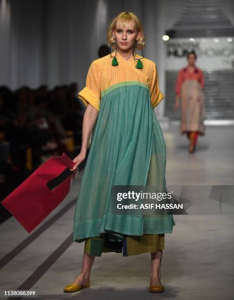 Model presents a creation by Pakistani fashion brand Umer and Imrana on the second day of the 'Hum Showcase' Fashion Week in Karachi on April 19,...