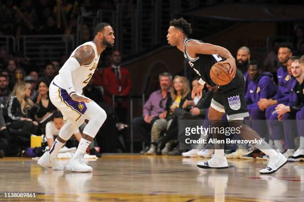 LeBron James of the Los Angeles Lakers plays defense against Buddy Hield of the Sacramento Kings at Staples Center on March 24, 2019 in Los Angeles,...
