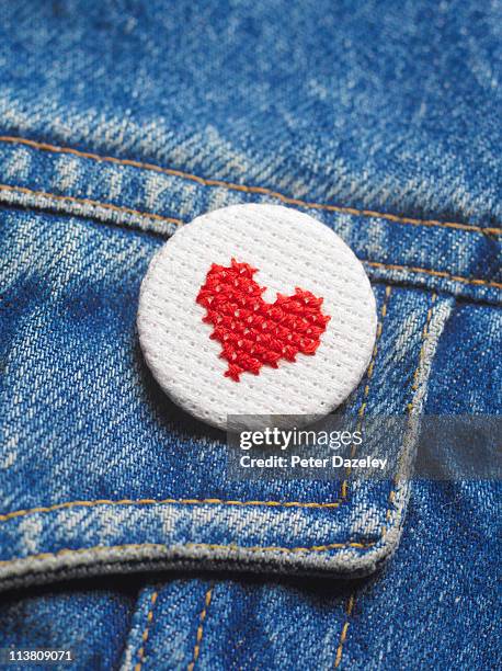 embroidered heart button badge on denim jacket - デニムジャケット ストックフォトと画像