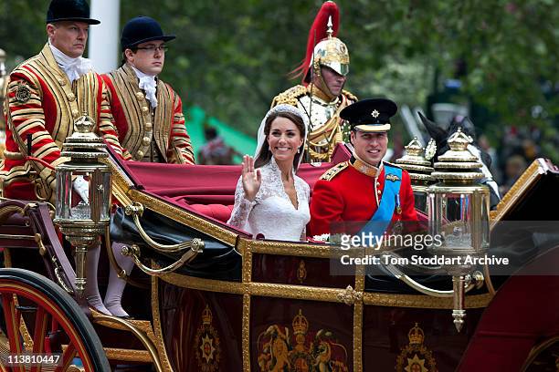 Catherine, Duchess of Cambridge and Prince William, Duke of Cambridge make the journey by carriage in procession to Buckingham Palace past crowds of...