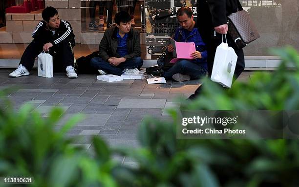 Man unpacks a new iPad 2 at the Sanlitun Apple Store on May 6, 2011 in Beijing, China. Apple Inc. Launched its iPad2 tablet computers in the Chinese...