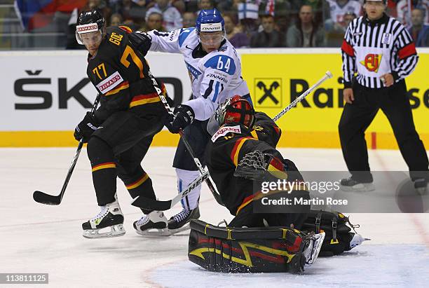 Dennis Endras of Germany makes a save on Mikael Granlund of Finland during the IIHF World Championship qualification match between Germany and...