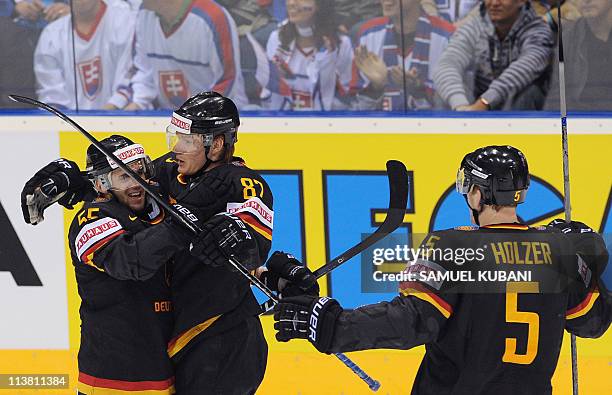 Germany's players Felix Schutz, Philip Gogulla, Korbinian Holzer celebrate their goal during the IIHF Ice Hockey World Championship Qualification...