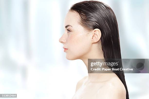 side profile of a young woman with her hair wet - hair back ストックフォトと画像