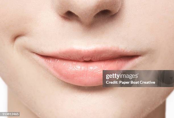 close up of smiling, natural lips - lippen stock-fotos und bilder