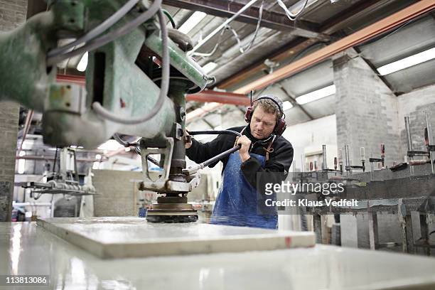 mature man polishing stone slab - baby boomer working stock pictures, royalty-free photos & images