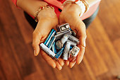 Closeup on different types of batteries in hand of housewife