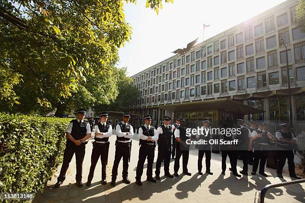 Police officers stand guard during a protest against the killing of Osama bin Laden outside the US embassy in Mayfair, attended by a rival...