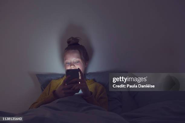 phone girl - girl in her bed stock pictures, royalty-free photos & images