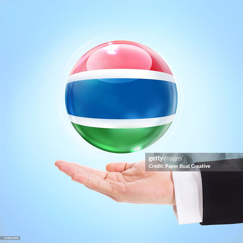 Flag of Gambia being supported by a hand