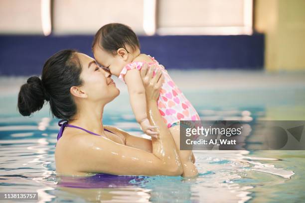 i'm glad we signed up for swimming class - baby swimmer stock pictures, royalty-free photos & images