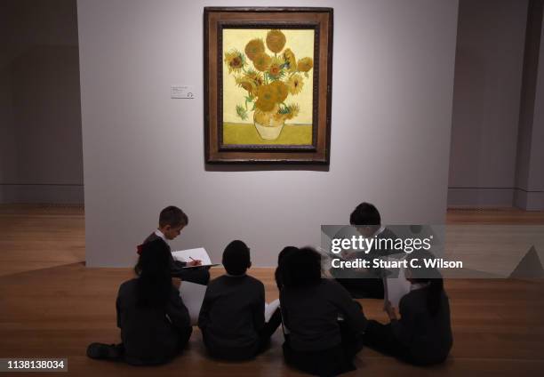 School children study Vincent van Gogh's Sunflowers painting at the EY Exhibition: Van Gogh and Britain press day which opens at Tate Britain on...