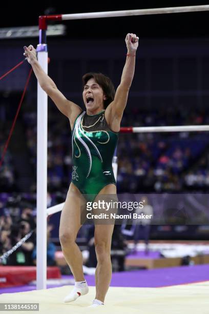Oksana Chusovitina celebrates after performing on the uneven bars during the Superstars of Gymnastics at The O2 Arena on March 23, 2019 in London,...