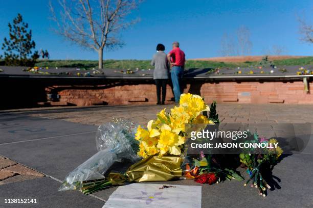 Flowers lie at the center of the Columbine Memorial at Clement Park in Littleton, Colorado, before a community vigil for the 20th anniversary of the...