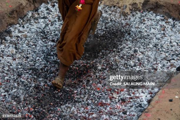 In this photo taken on April 19 a Hindu devotee walks over hot coals while taking part in the Yankin Moekaung firewalk festival in Yangon.