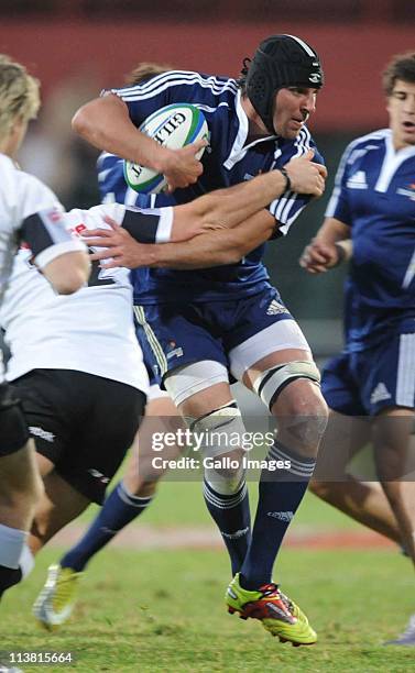 Benjamin Macome is tackled during the Vodacom Cup semi-final match between Pampas XV and Sharks XV from Profert Olen Park on May 06, 2011 in...