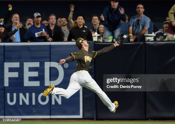 Wil Myers of the San Diego Padres makes a leaping catch on a ball hit by Jose Peraza of the Cincinnati Reds during the sixth inning of a baseball...